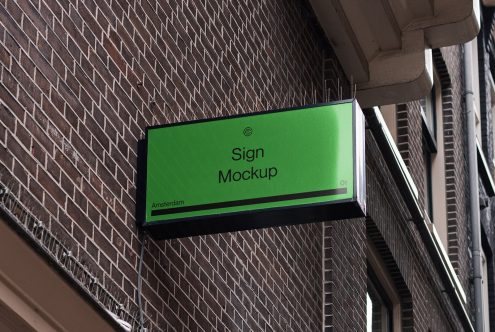 Outdoor rectangular store sign mockup against brick wall for graphic designers, showcasing storefront branding in urban setting.